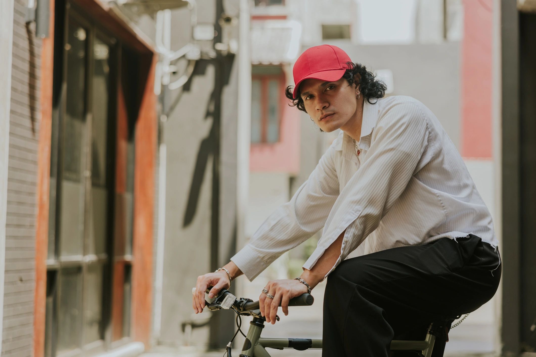 Fashion portrait of a trendy young man with bicycle