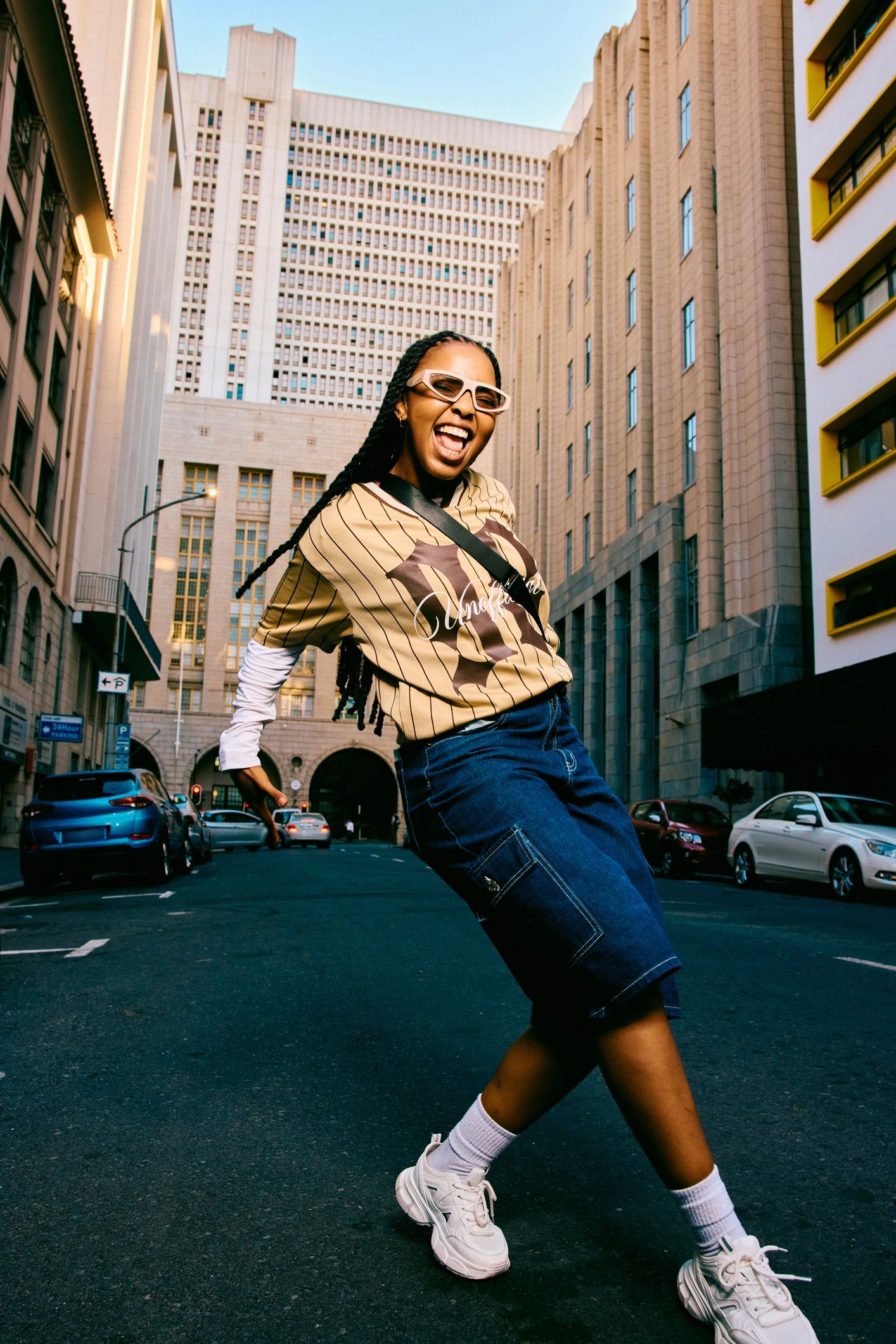 Young woman in streetwear dancing on a city street